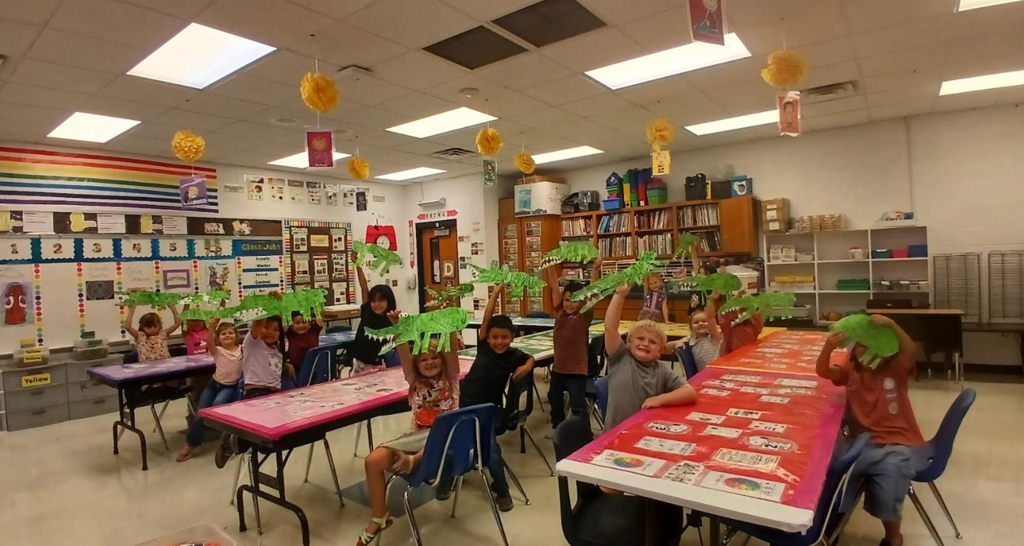 students showing their paper crocodiles
