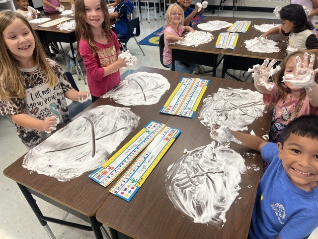 students with shaving cream at table