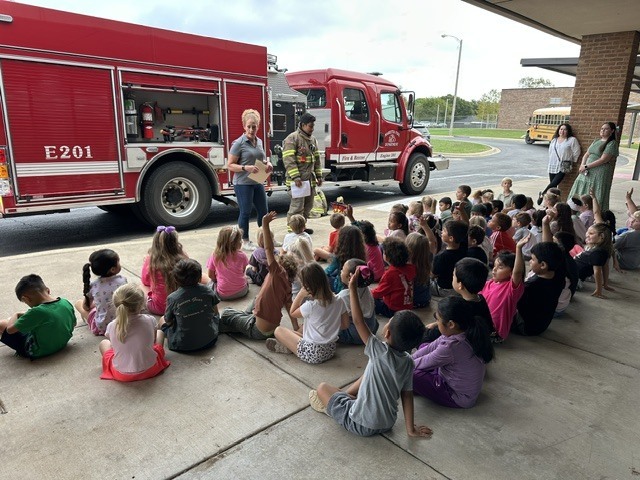 kids watching firefighter presentation