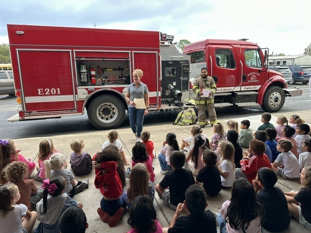 kids watching firefighter presentation