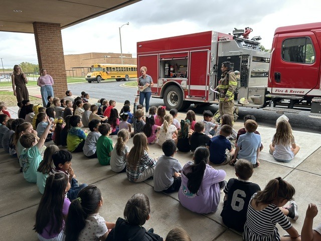 kids watching firefighter presentation
