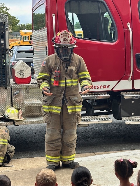 kids watching firefighter presentation