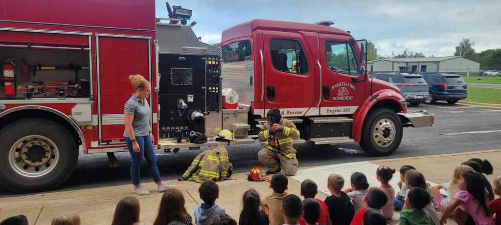 kids watching firefighter presentation