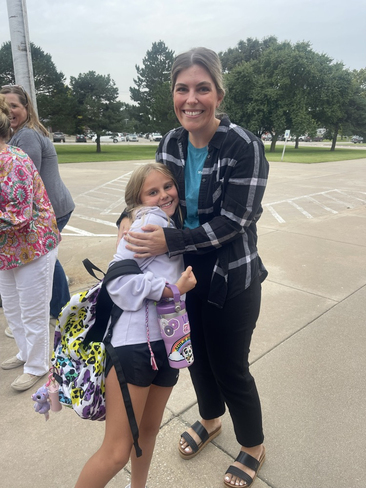 A MES student gives her aunt who was greeting students a hug