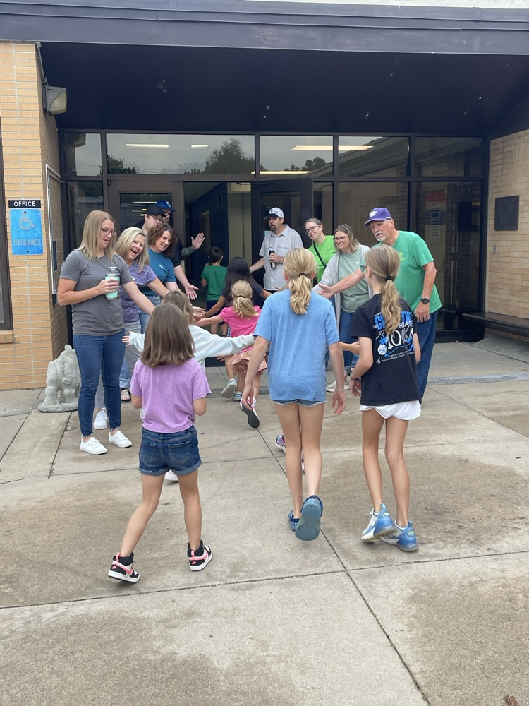 Students walk through the greeting line