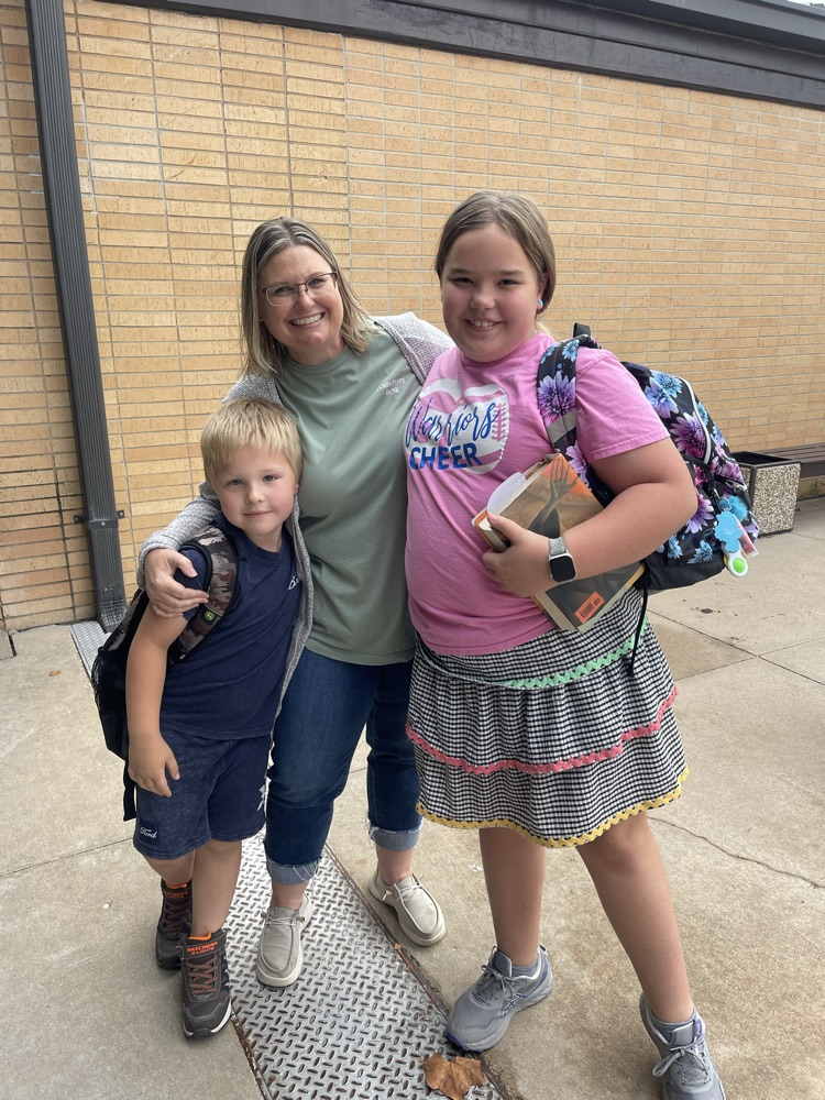 Always fun to see your niece and nephew. A greeter poses with her niece and nephew for a picture.