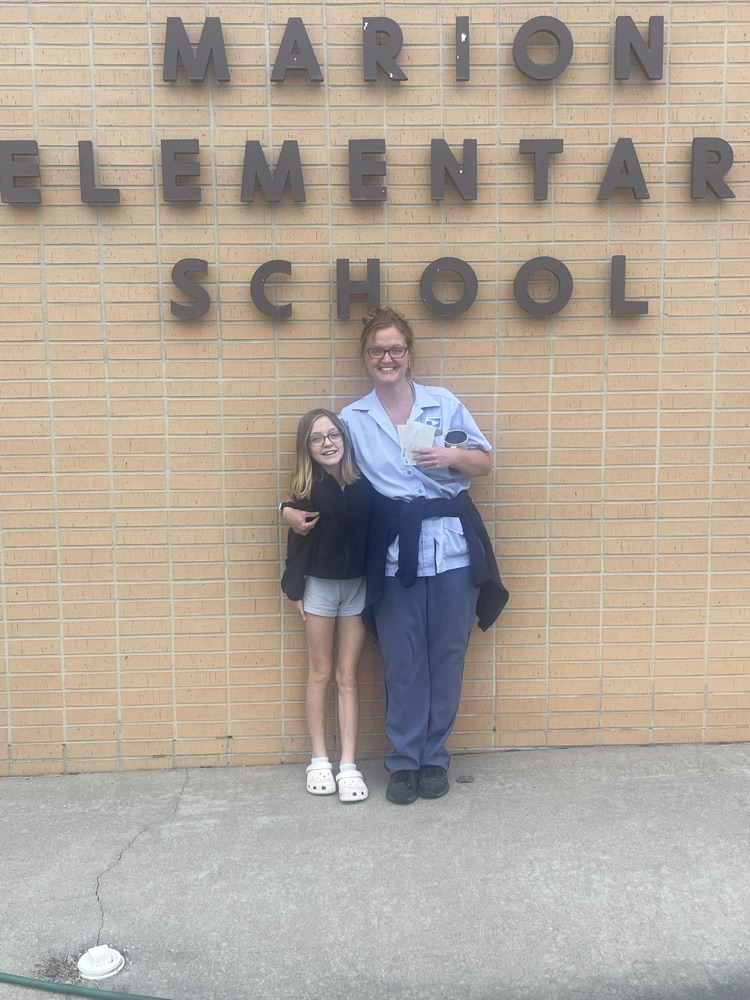 A mother poses with her daughter in front of Marion Elementary School.