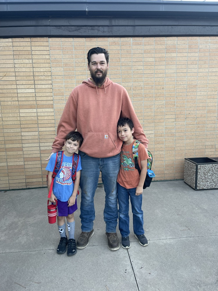 All smiles when 2 students see their dad greeting for Welcome Wednesday