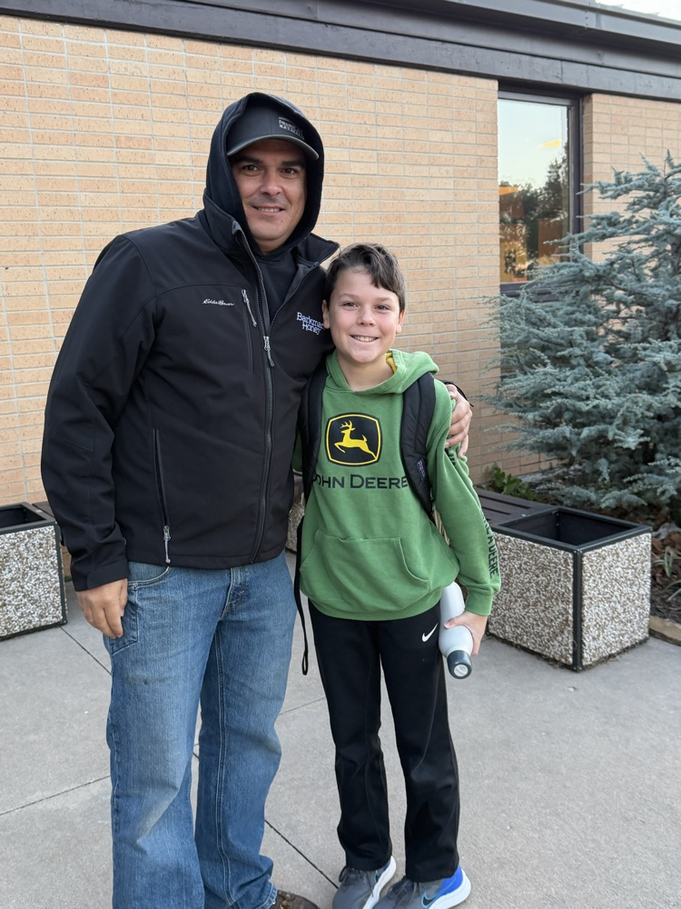 A son and dad pose for a picture on Welcome Wednesday