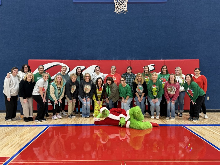 The Grinch poses with the MES staff for a picture.  