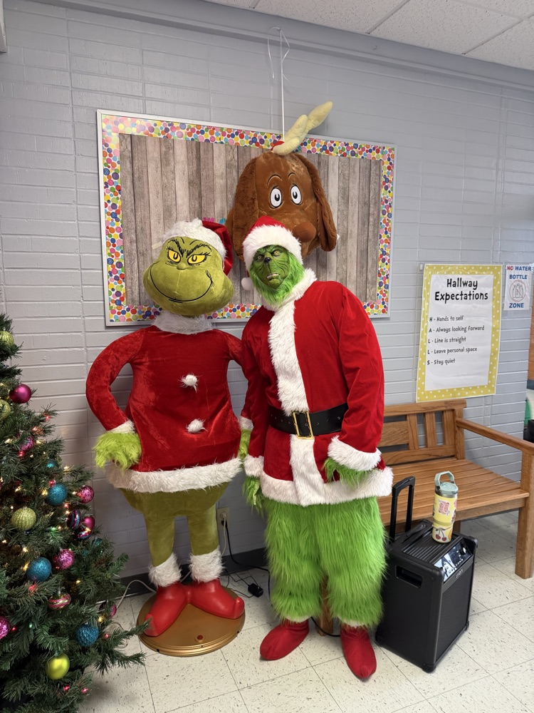 Two Grinches pose for a picture together