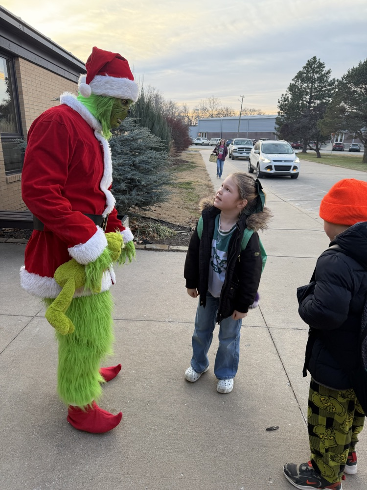 A student looks at The Grinch trying to figure him out