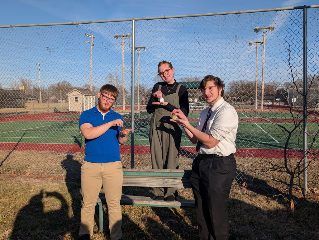 Eldon Smith, Gabby Stuchlik, and Jaxon Salsbury pose with their state qualifying medals. 