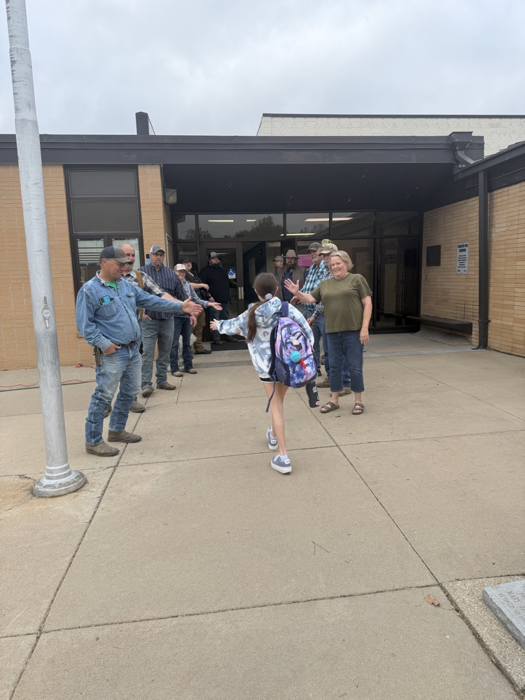 Greeting students as they walk into school