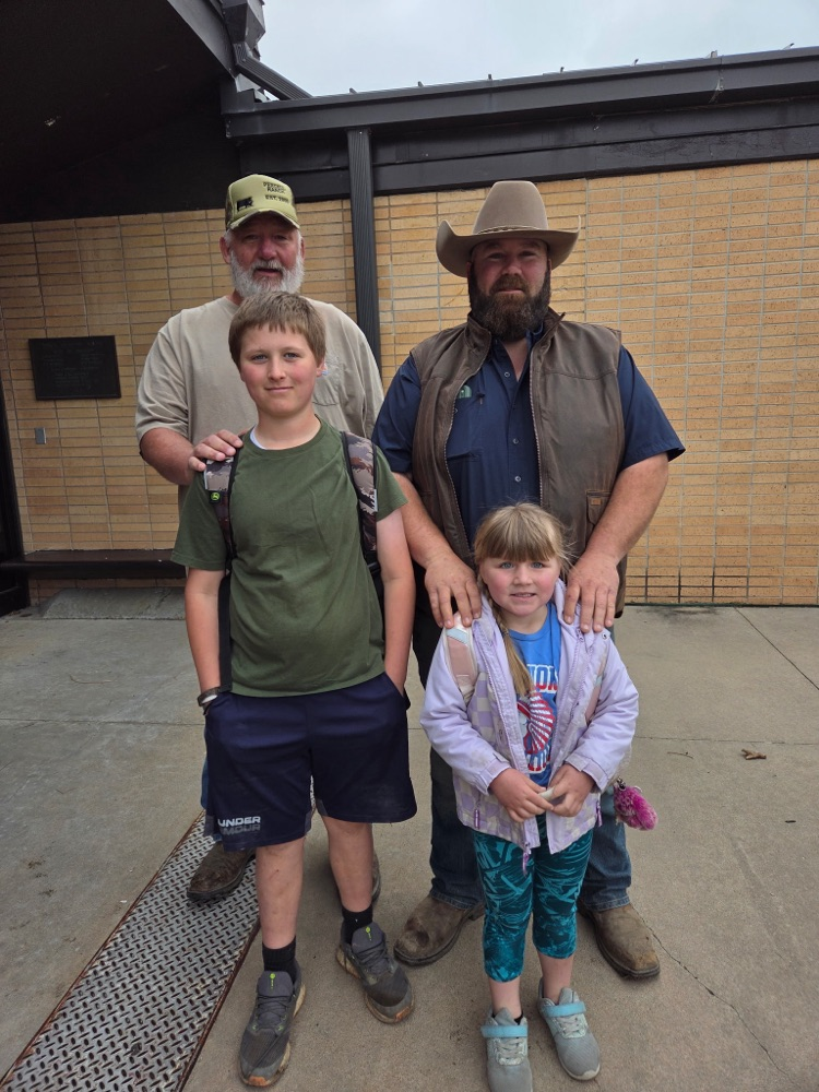 Two students with their dad and their grandpa