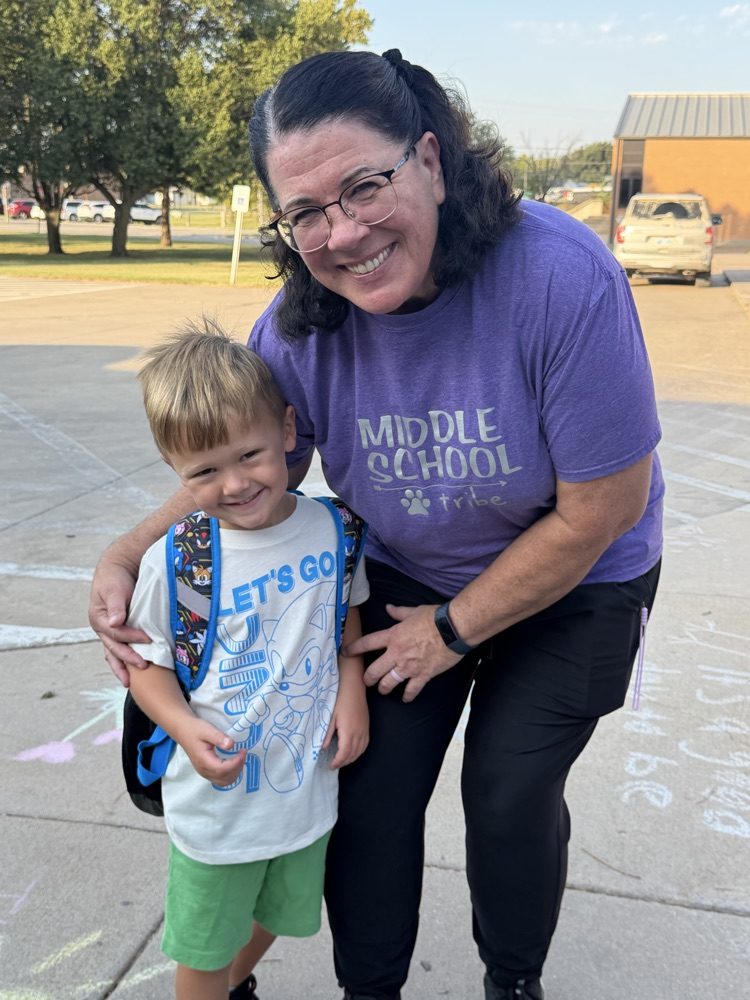 A retired MMS principal gets a hug from her grandson