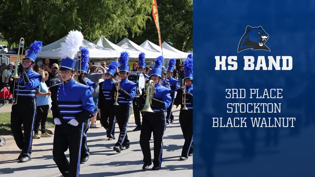 The MCE marching band marches down the street.