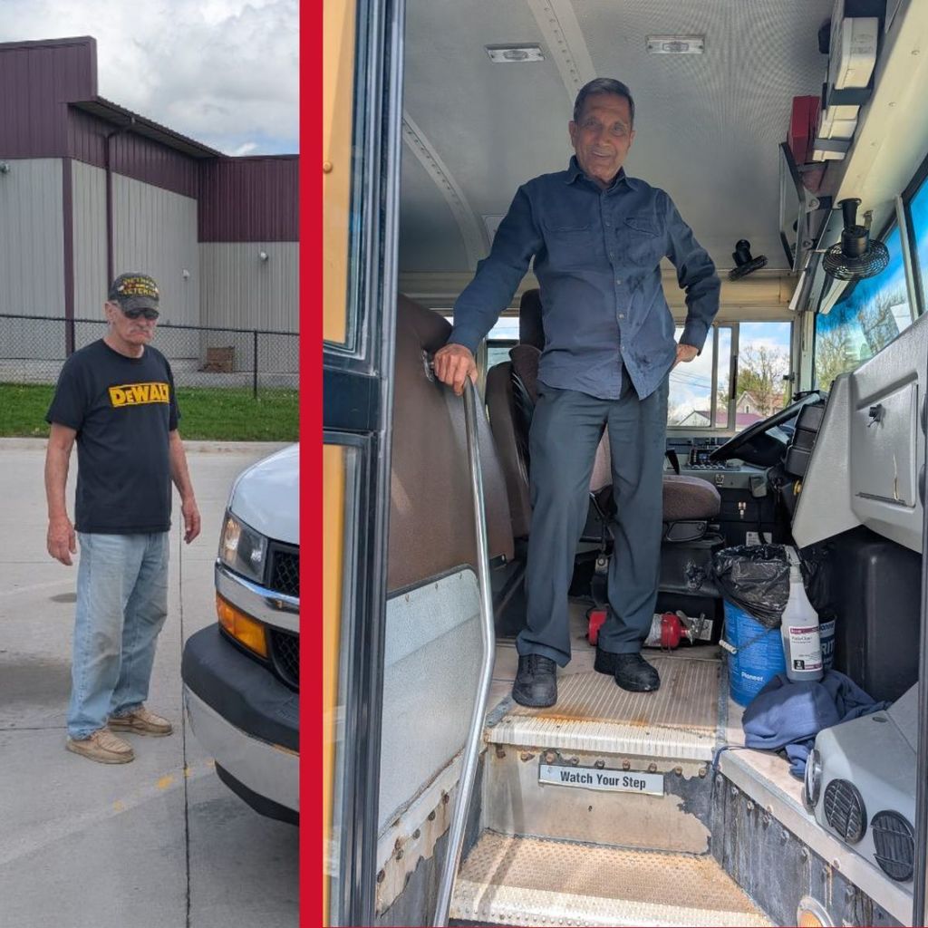 Man in from of van. Man smiling and standing at bus entrance. 