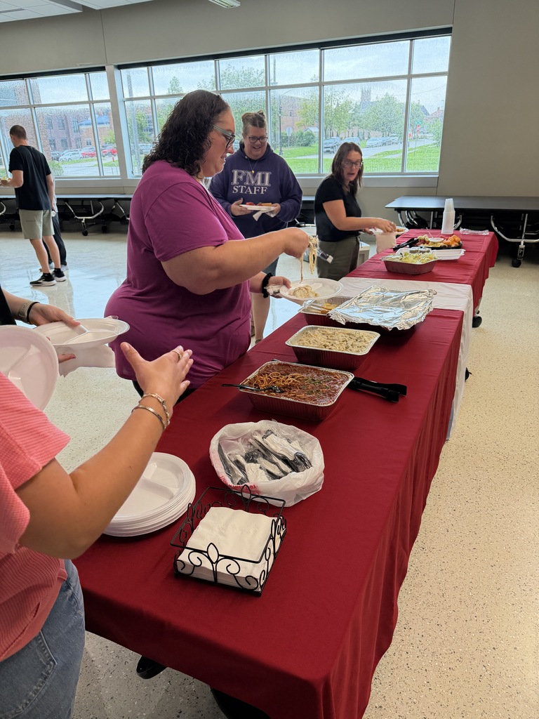 Staff members moving through the buffet lunch line. 
