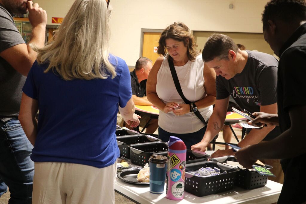 Staff fill out giveaway items. 