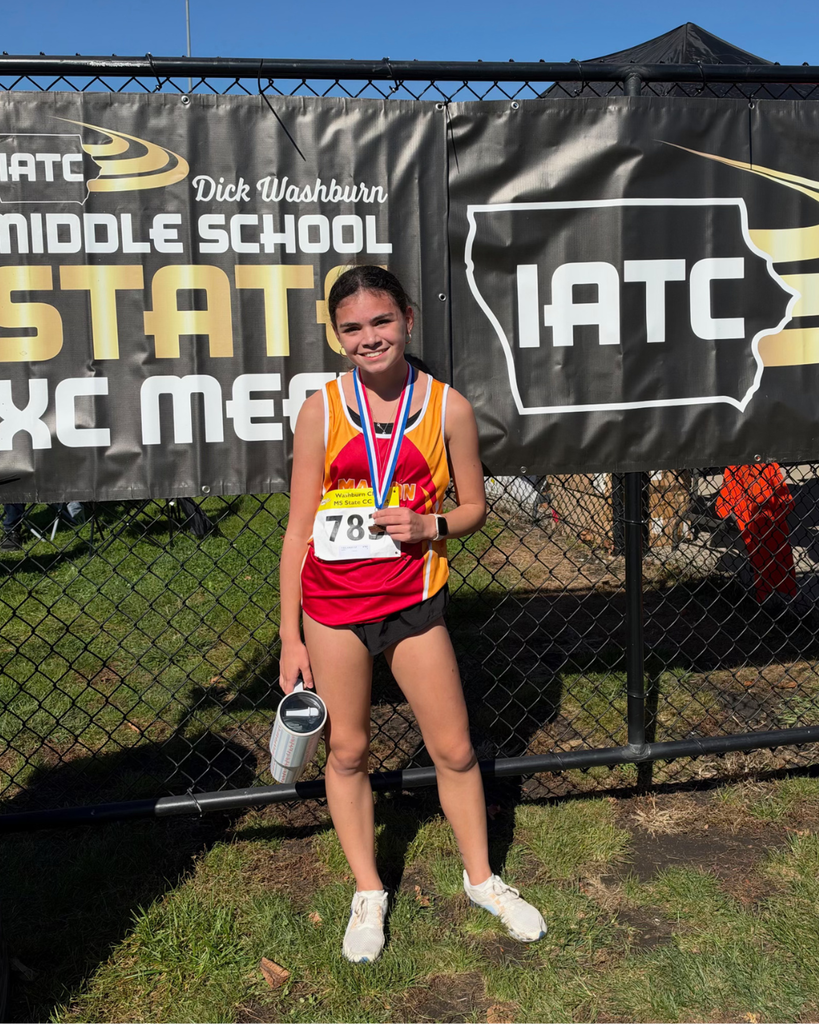 Sofi V. posing with medal after Cross Country race.