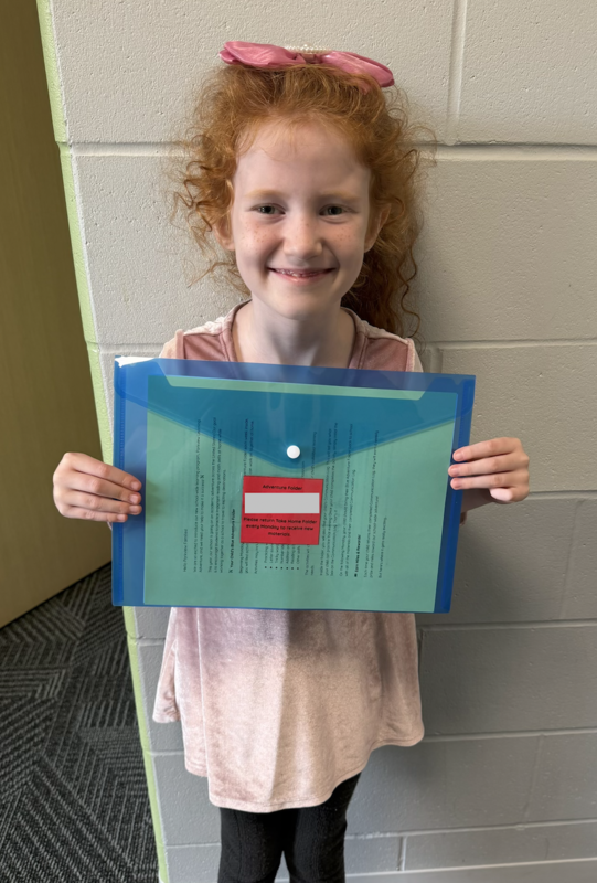 student holding blue folder