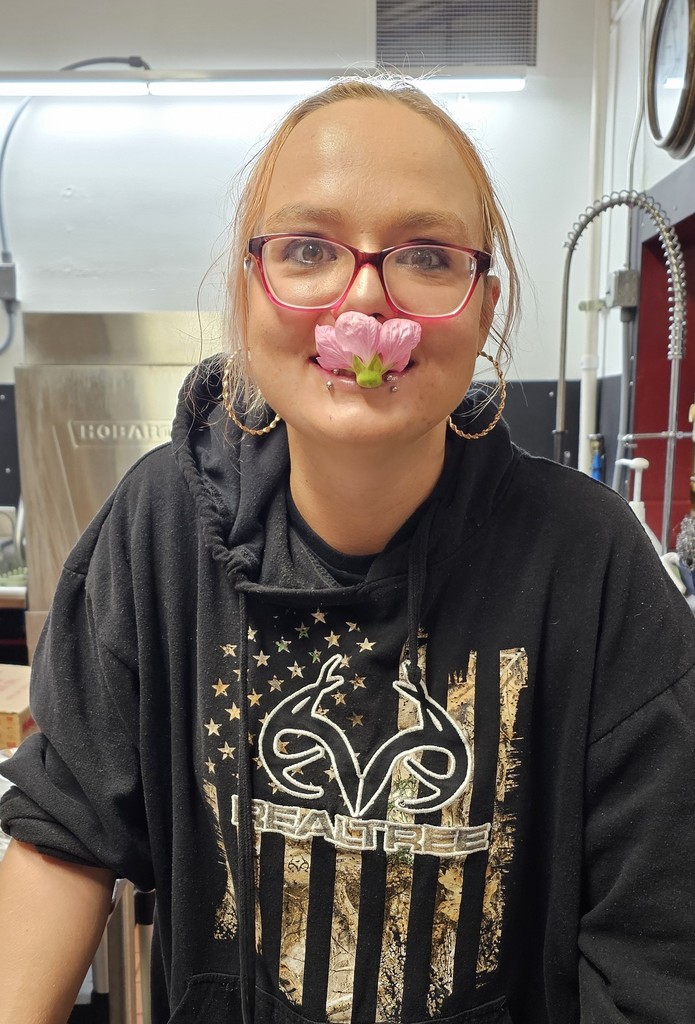 Holly trying a flower