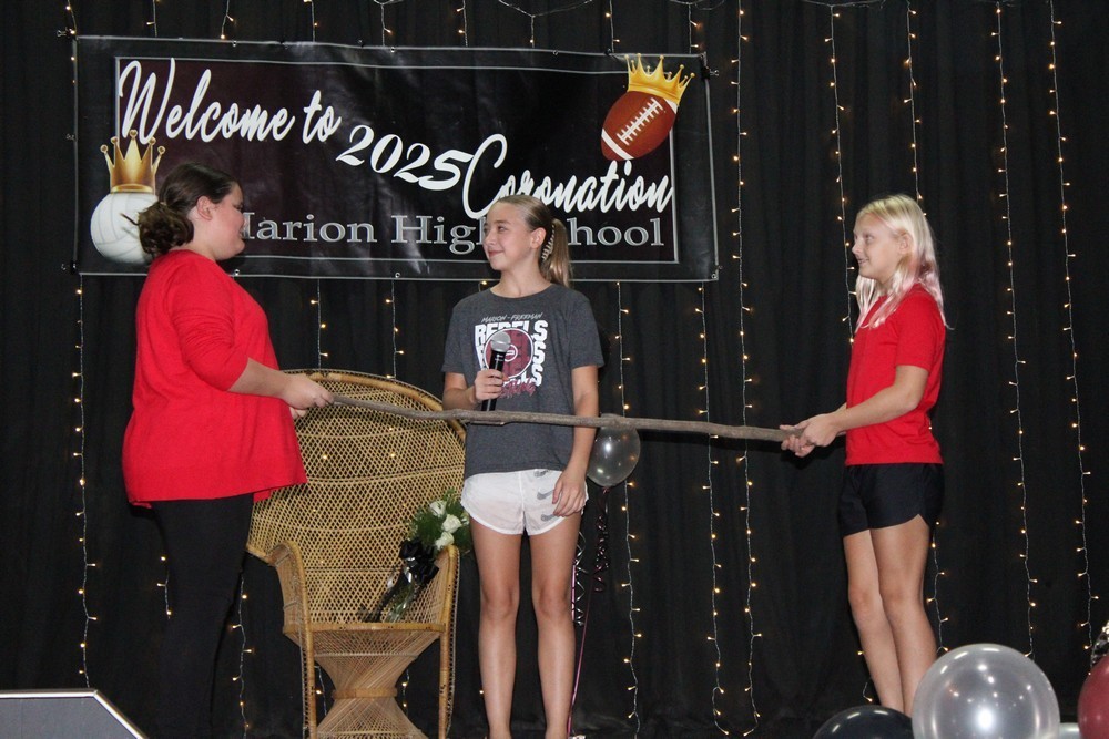 3 girls on stage doing skit