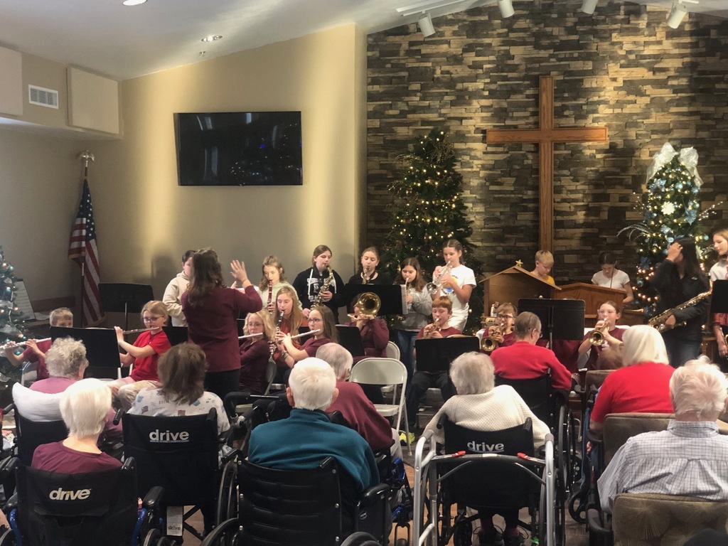 Students playing instruments at nursing home