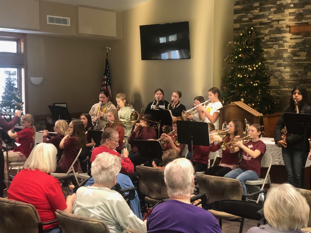Students playing instruments at nursing home
