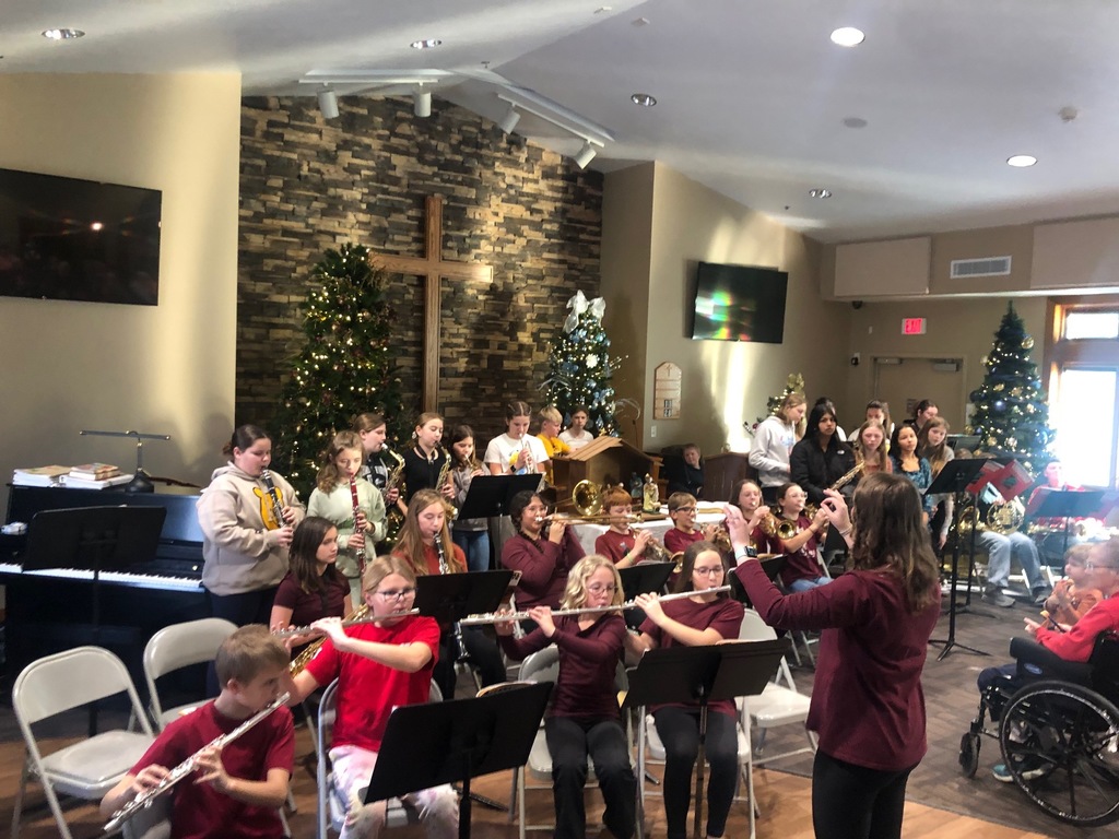 Students playing instruments at nursing home