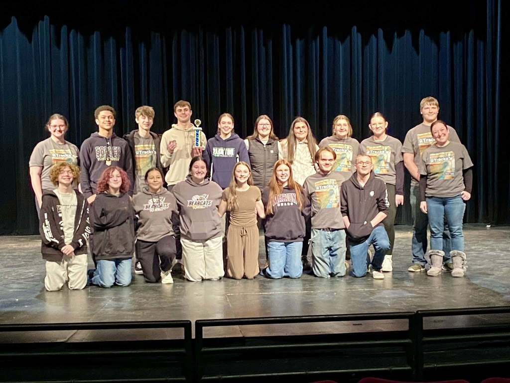 One Act students on stage with award