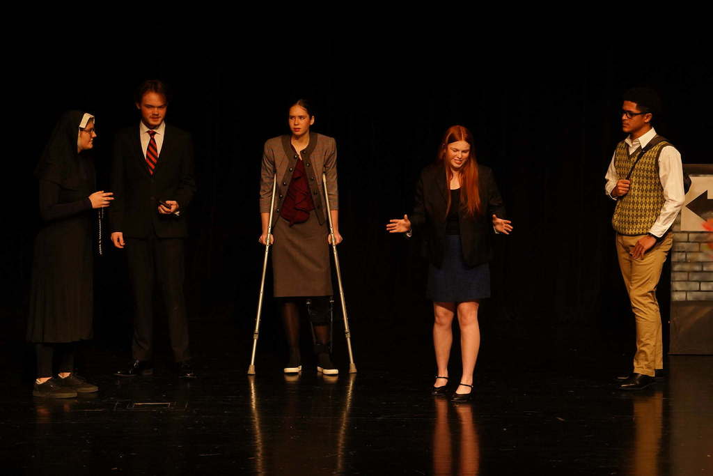 5 students acting on stage