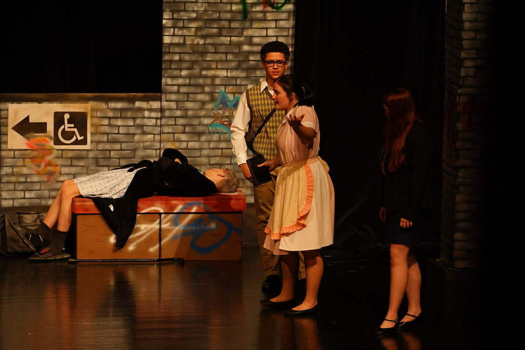 4 students acting on stage