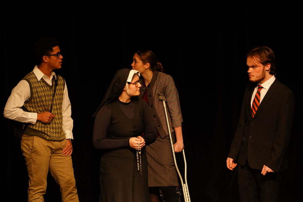4 students acting on stage