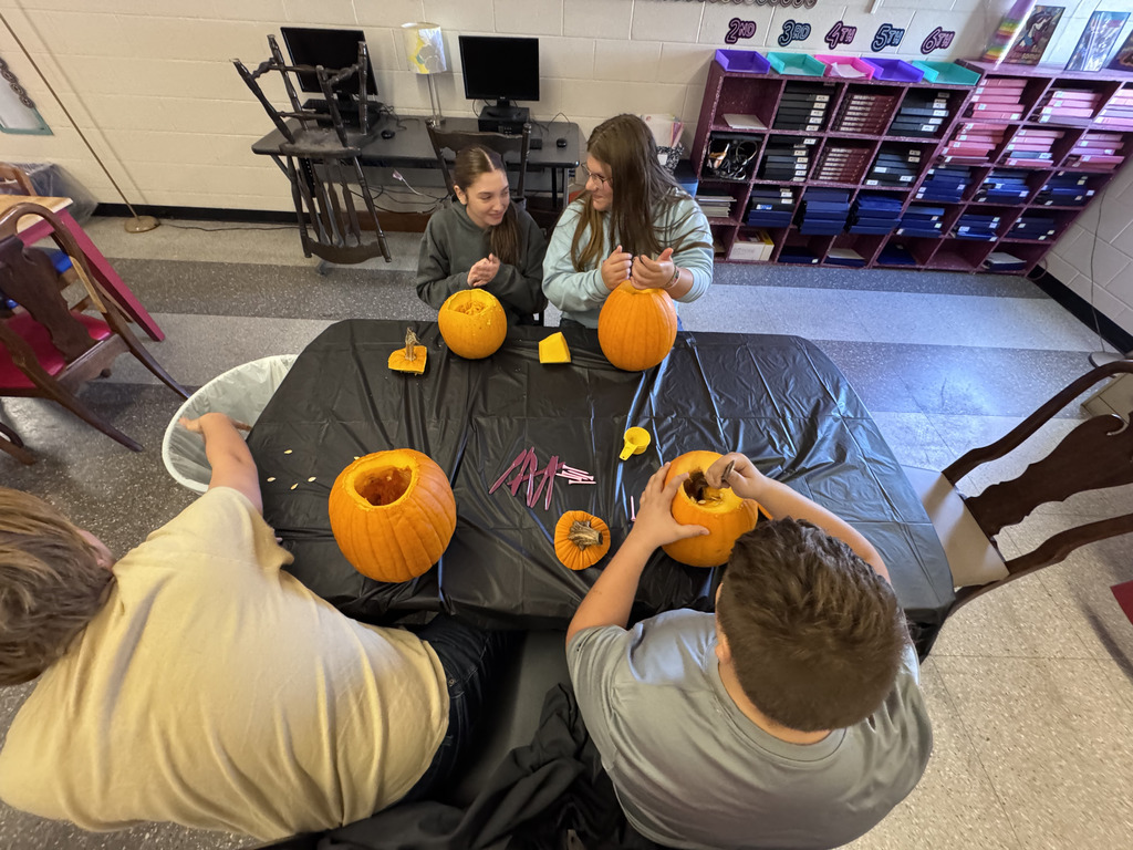 Students carving pumpkins