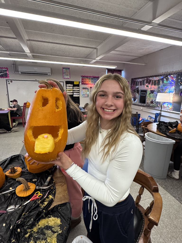 Students carving pumpkins