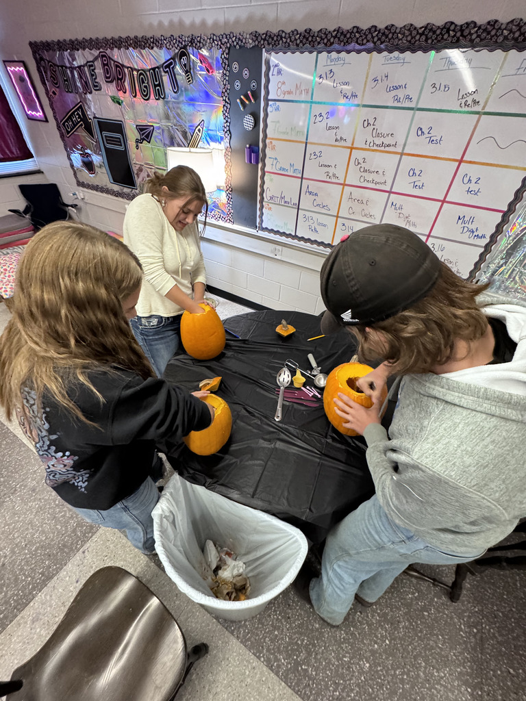 Students carving pumpkins