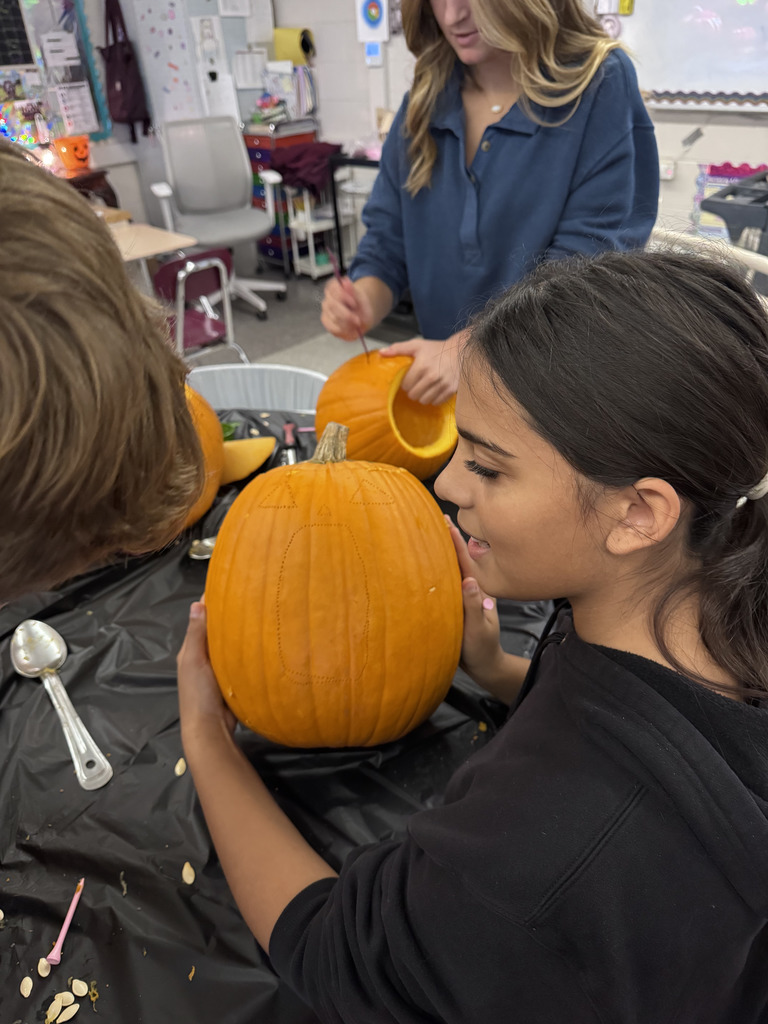 Students carving pumpkins