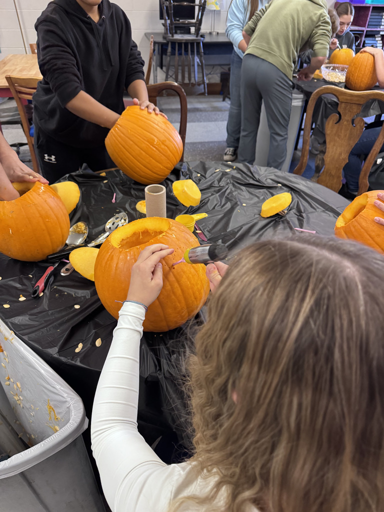 Students carving pumpkins