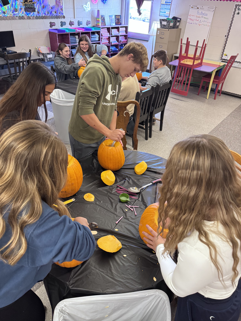 Students carving pumpkins