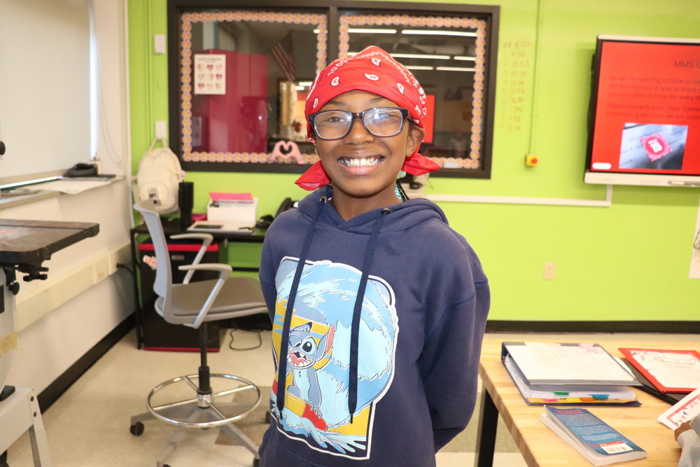 A student wearing a red bandana