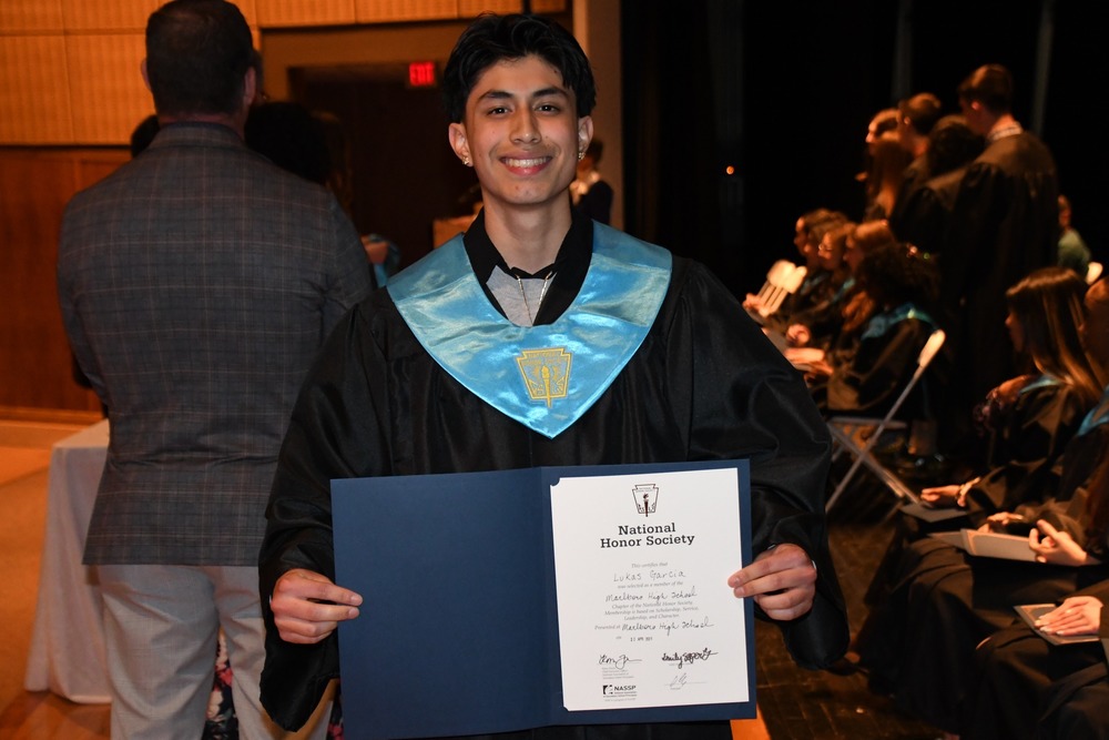 Student holding National Honor Society Certificate