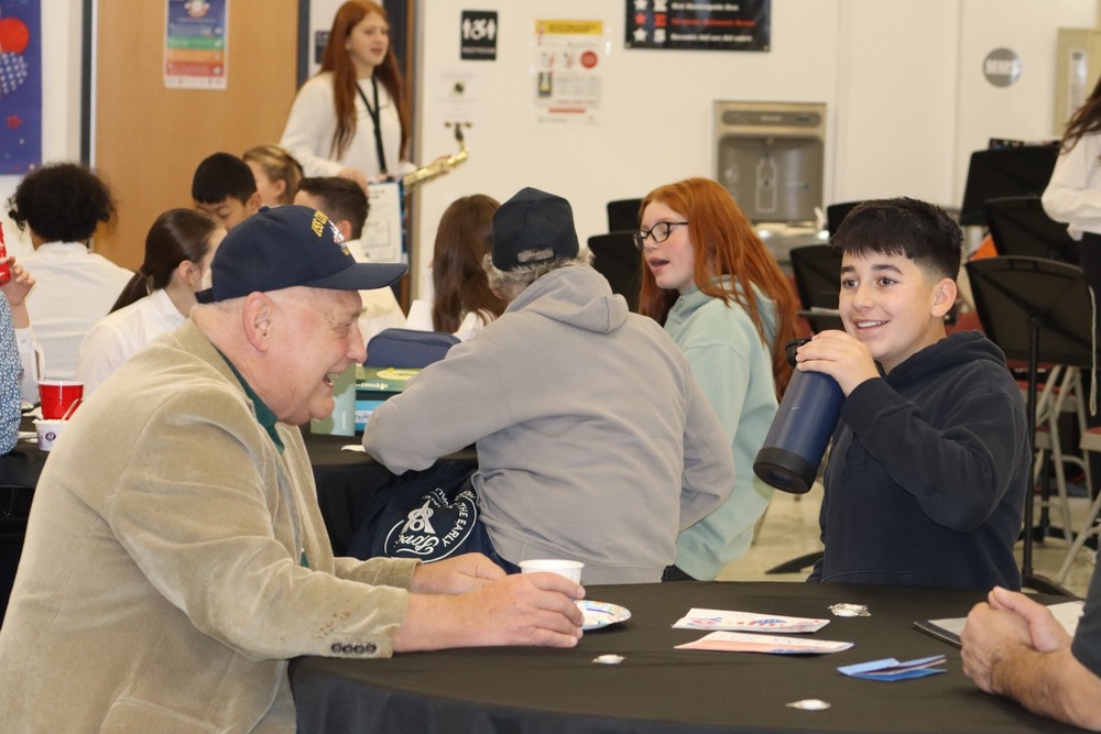 A student sits with a veteran