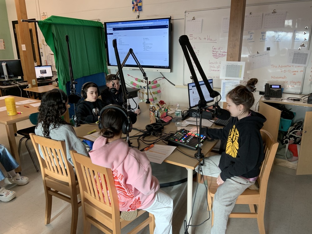 Students gathered around broadcasting equipment