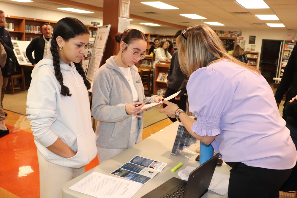 Students speak with a faculty member