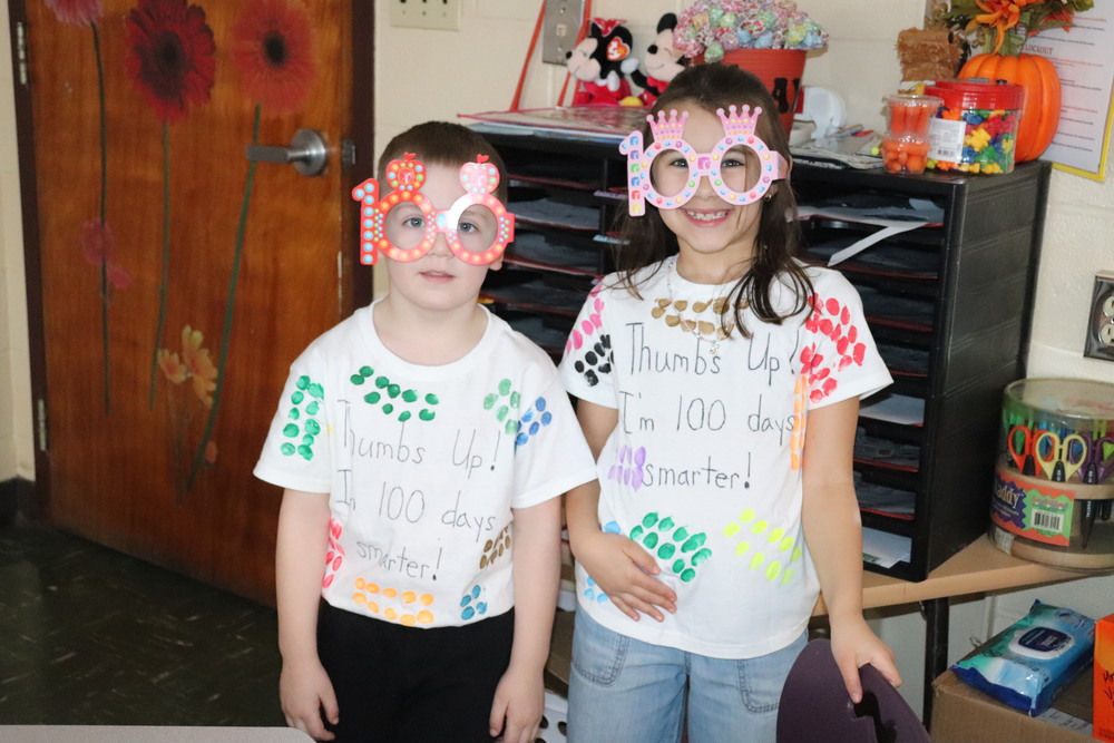 Two young students wearing #100 glasses