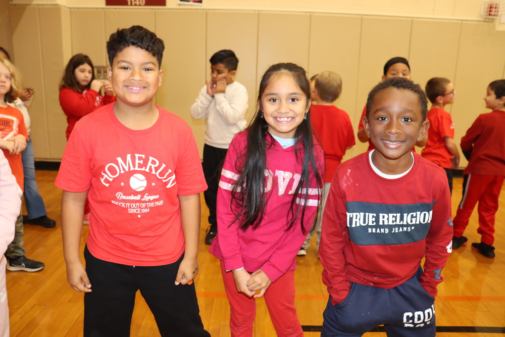 Three students wearing red