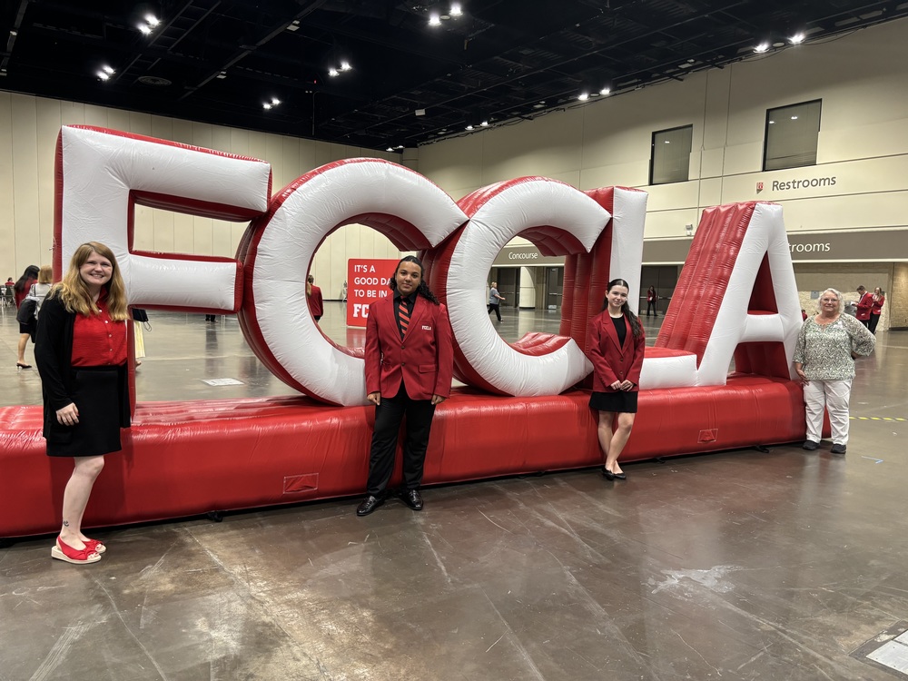 FCCLA members stand in front of an FCCLA sign