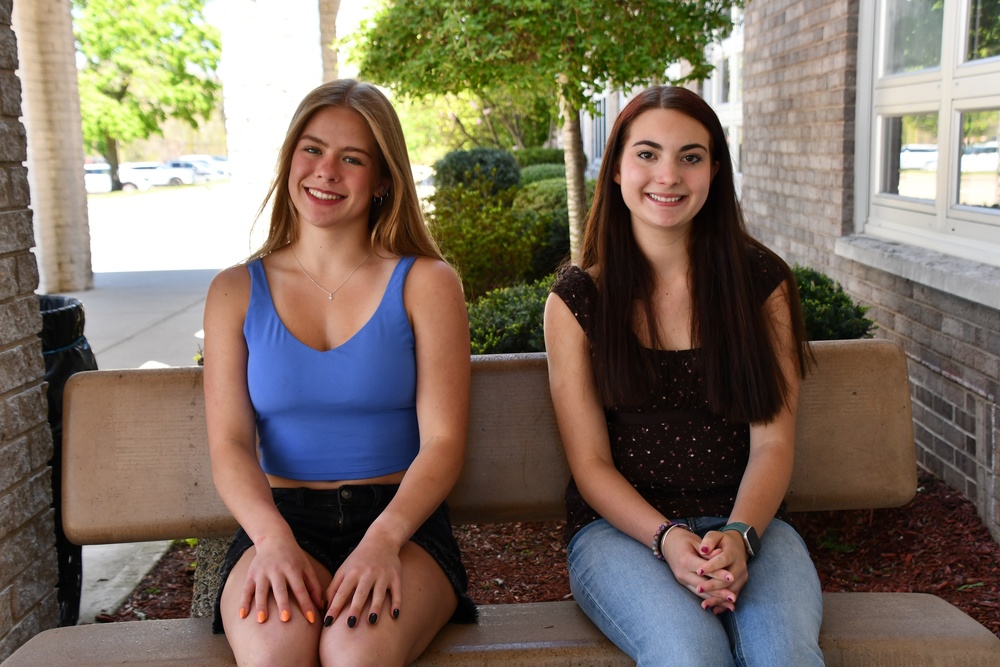 two students sitting on bench